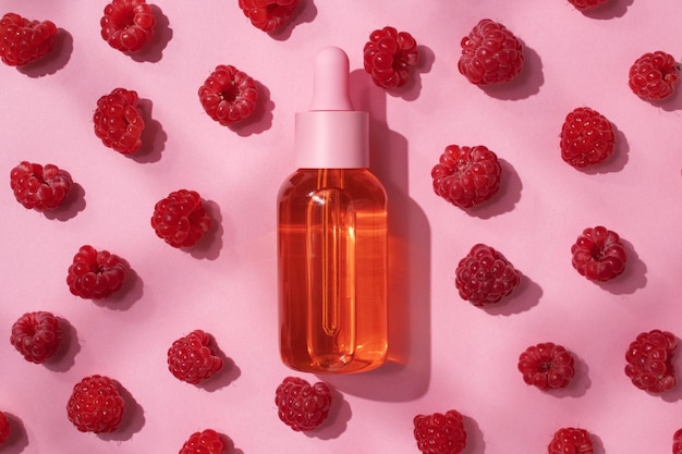 Cosmetic bottle of oil and raspberries Essential oil collagen serum for beauty SPA natural organic cosmetics packaging design