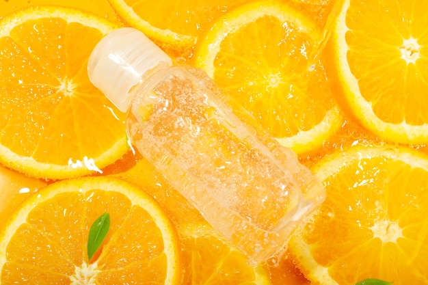 Cosmetic bottle and orange slices close up