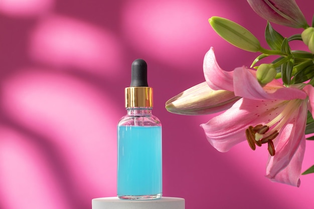 Cosmetic bottle on podium with lily flower and shadow on pink background Face and body care spa concept Hyaluronic acid oil serum with collagen and peptides skin care product