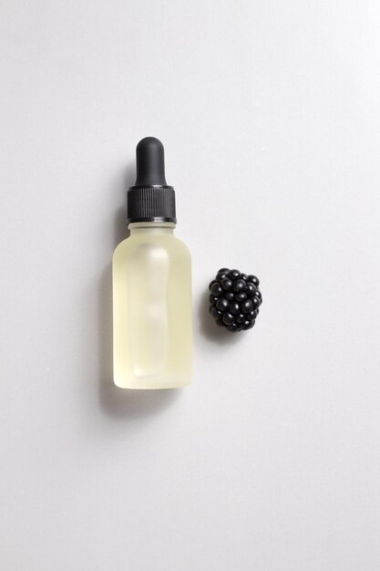 Cosmetic bottle of serum and blackberries Essential oils packaging design collagen serum for beauty