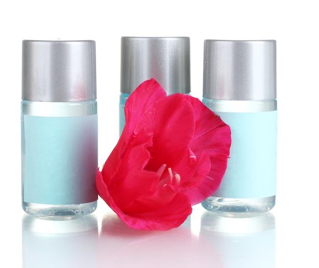 Cosmetic bottles and flower isolated on white