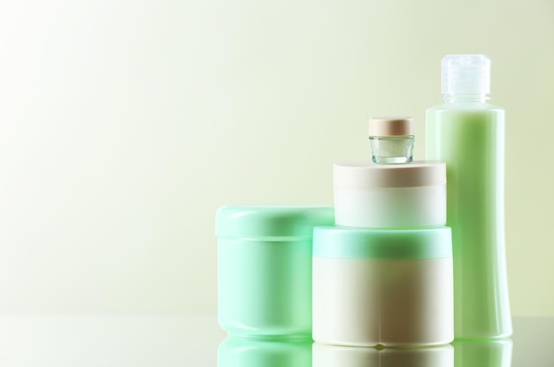 Cosmetic bottles on light background