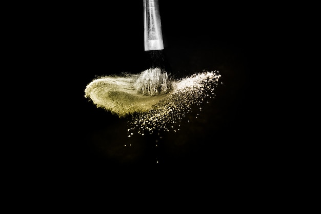 Cosmetic brush with golden cosmetic powder spreading