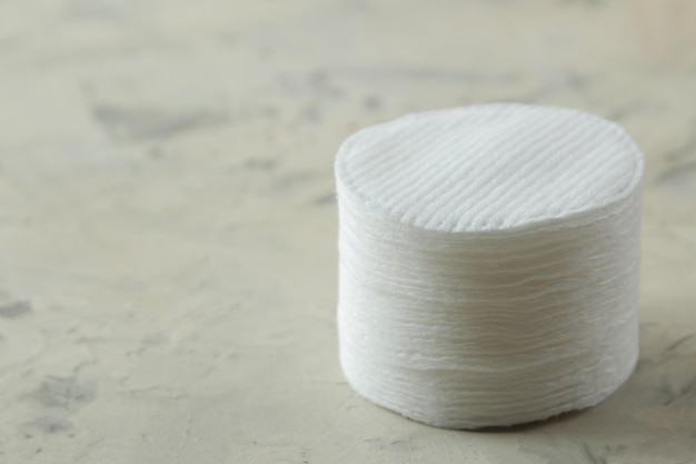 Cosmetic cotton pads. A stack of cotton pads on a light concrete background. spa. close-up.