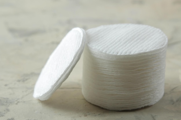 Cosmetic cotton pads. A stack of cotton pads on a light concrete background. spa. close-up.