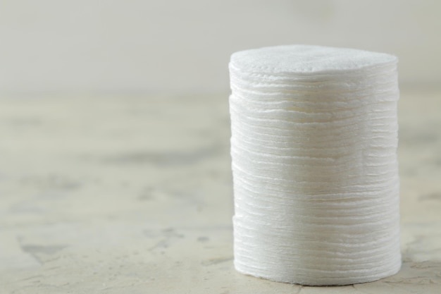 Cosmetic cotton pads. A stack of cotton pads on a light concrete background. spa. close-up.