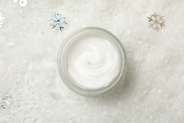 Cosmetic cream on decorative snow background