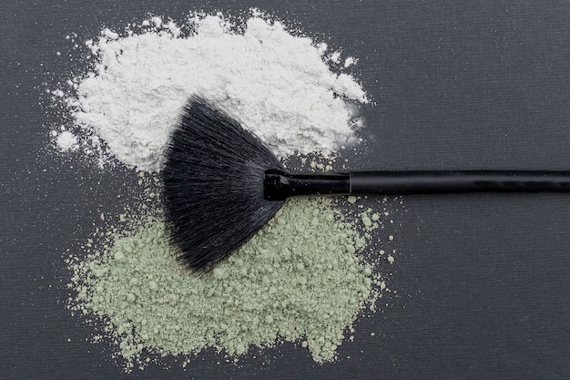 cosmetic dry white and green clay powder with brush