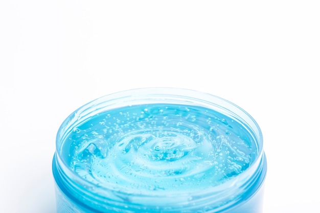 Cosmetic gel in a jar on a white background blue transparent gel with texture and bubbles isolate