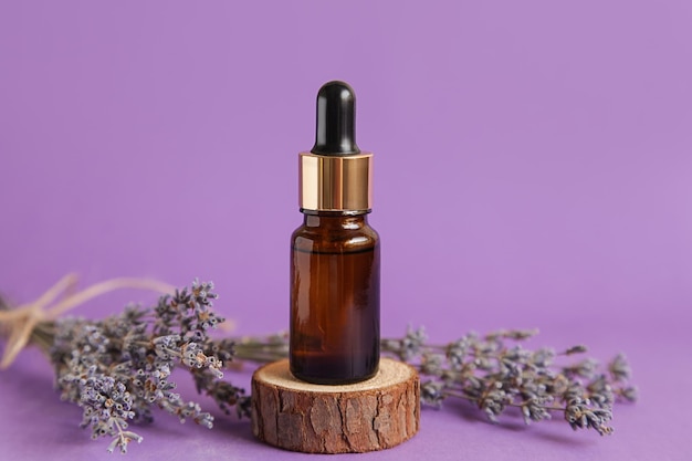 Cosmetic glass bottle for essential oil Lavender Mockup Lavender Cosmetics Podium on violet background