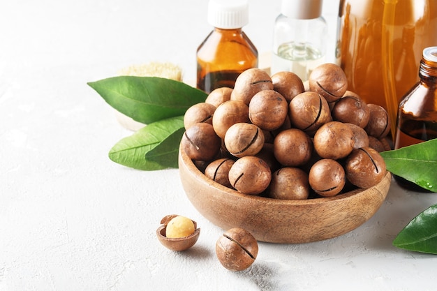 Cosmetic macadamia nut oil on a grey concrete table.