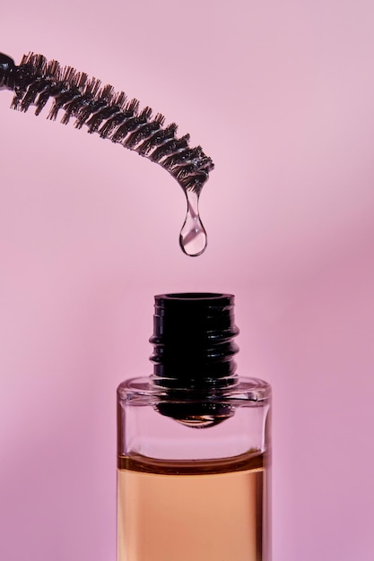 Photo cosmetic oil for the growth of eyebrows and eyelashes with a brush