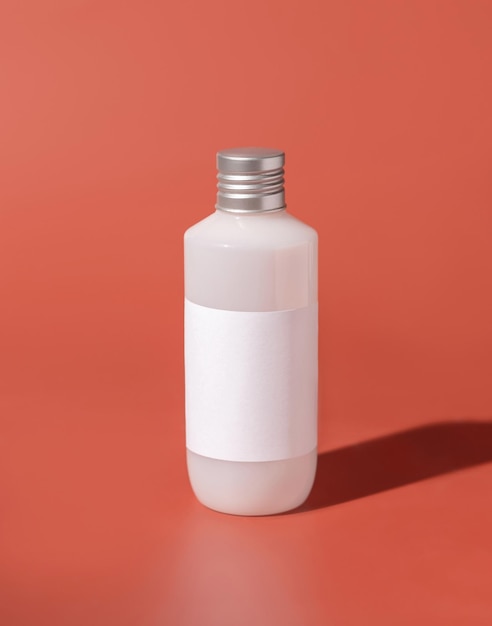 Cosmetic Plastic bottle with blank label on pink hard shadows Mockup