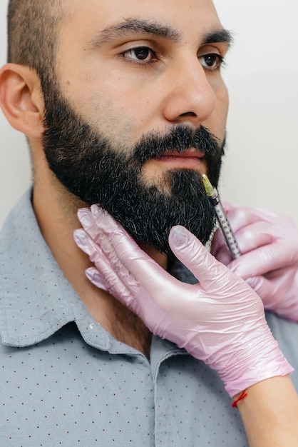 Cosmetic procedure for lip augmentation and wrinkle removal for a bearded man. Cosmetology.