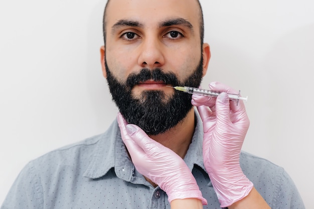 Cosmetic procedure for lip augmentation and wrinkle removal for a bearded man.