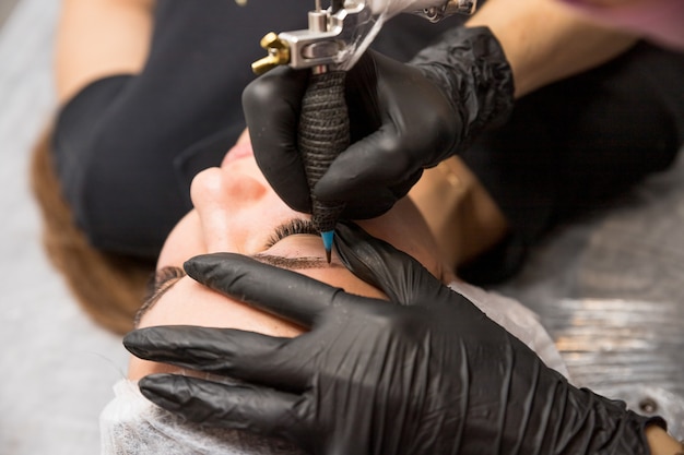 Cosmetic procedures for the treatment of eyebrows. Microblading in the beauty salon. Professional cosmetology. The process of applying the pigment,shaping eyebrows.permanent makeup eyebrows, tattooing