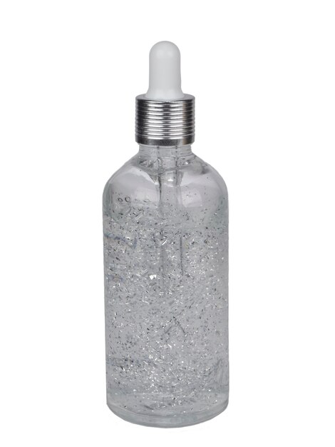 Cosmetic serum or cream in a bottle with silver sparkles