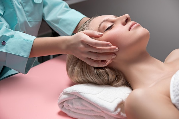 Cosmetician doing receiving facial massage