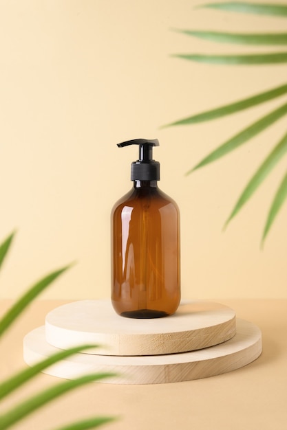 Cosmetics bottle on wooden natural podium with tropical leaves concept natural cosmetics for body