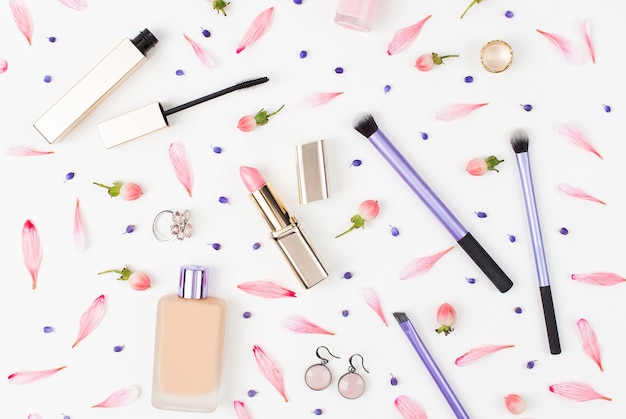 Cosmetics collage with lipstick brush and other accessories on white background