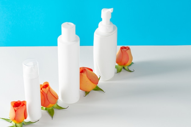 Cosmetics containers decorated with orange rose petals