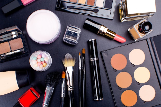 Cosmetics on dark background, closeup