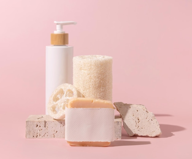 Cosmetics and skin care accessories near stones on light beige close up Mockup