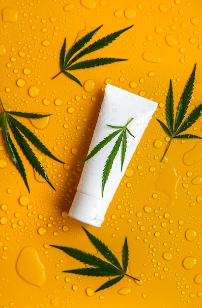 Cosmetics with cannabis extract on a wet background Selective focus