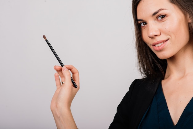 Cosmetologist beautician holding a tool in her hands, permanent makeup master, permanent makeup, tattoo pen, close up