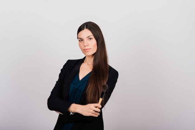 Cosmetologist beautician holding a tool in her hands, permanent makeup master, permanent makeup