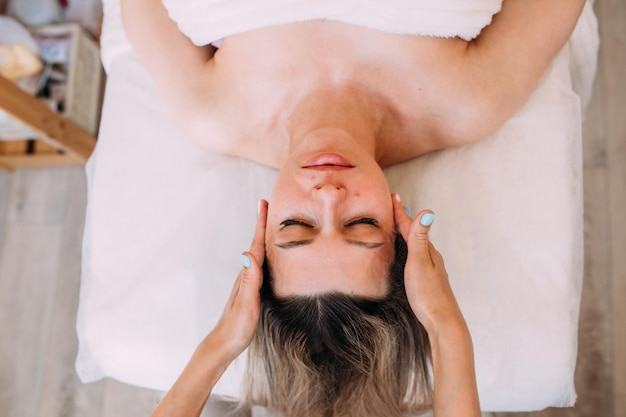 Cosmetologist does facial massage for woman Beauty skin care