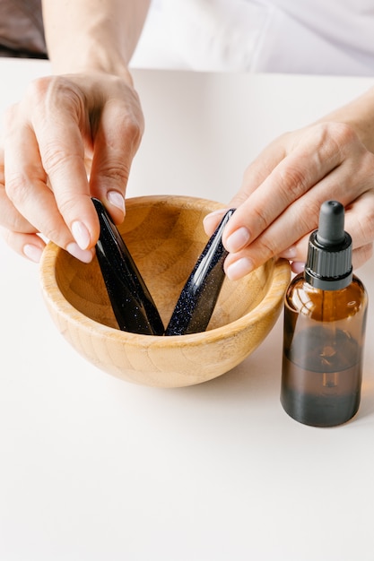 Cosmetologist holding cosmetic products.