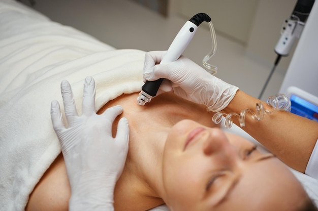 A cosmetologist performs hydropiling in a beauty salon Skin care