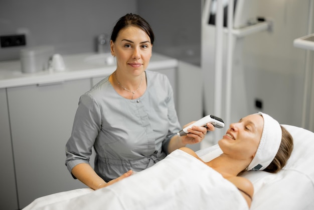 Cosmetologist with woman client during a consultation