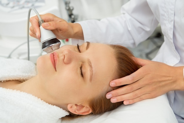 Cosmetologist working with her client at the beauty clinic