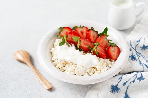 Cottage cheese, curd cheese with strawberries berries in a bowl 