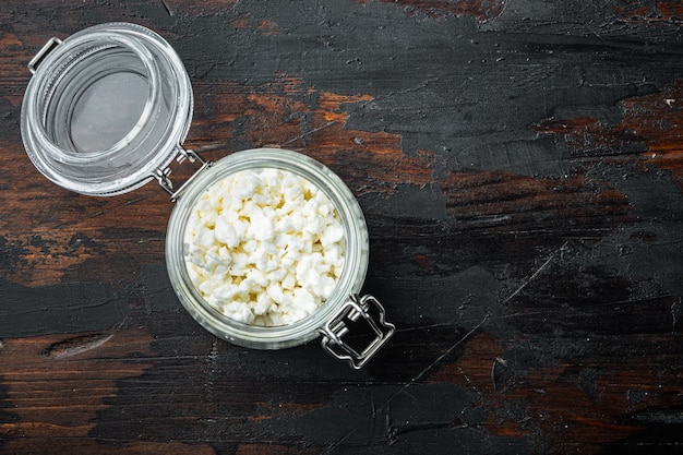 Cottage cheese or curd, on old wooden table, top view with space for text