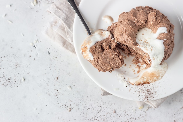 Cottage cheese dessert decorated with white chocolate glaze, coconut flakes and cocoa powder