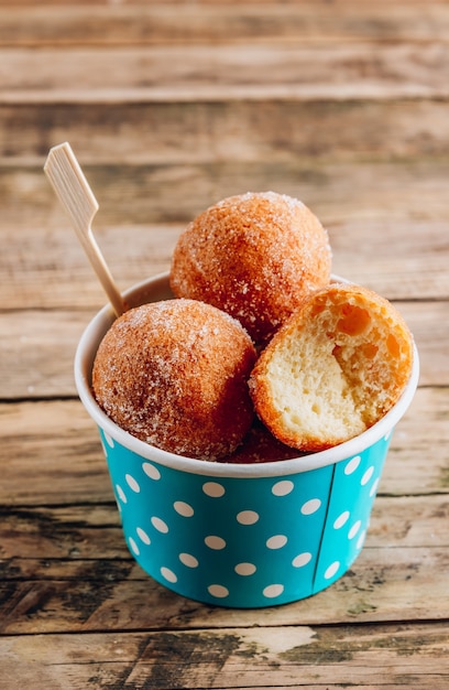 Cottage cheese donuts on a paper cup