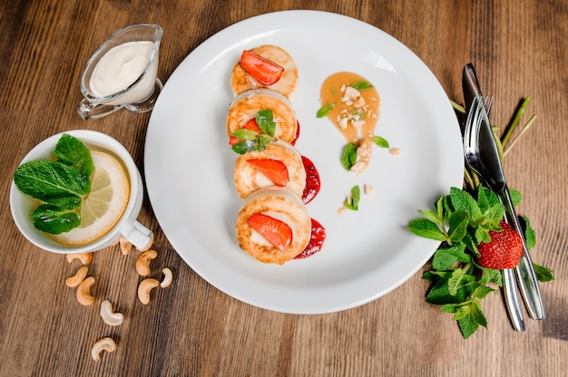 Cottage cheese pancake with berries on a wooden table