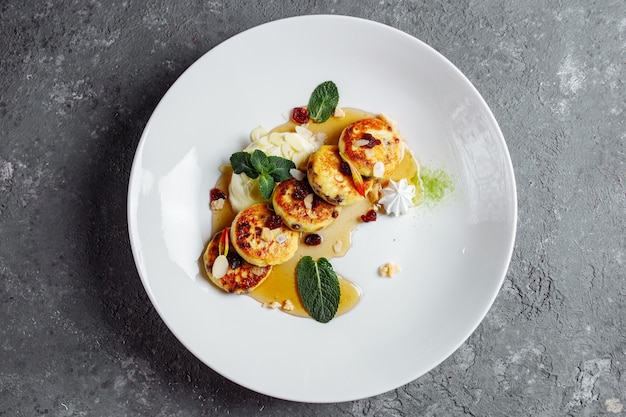 Cottage cheese pancakes or curd fritters decorated powdered sugar in plate