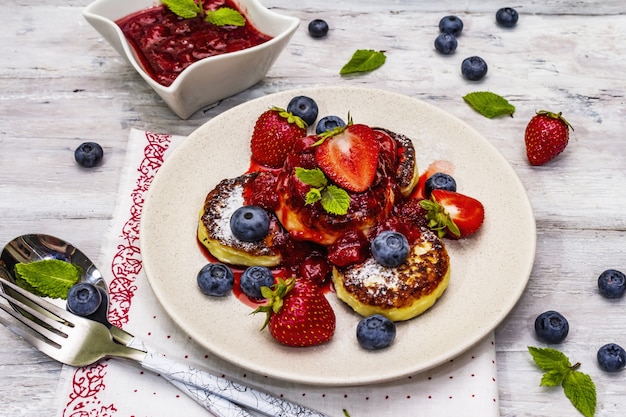 Cottage cheese pancakes with fresh berries and strawberry sauce