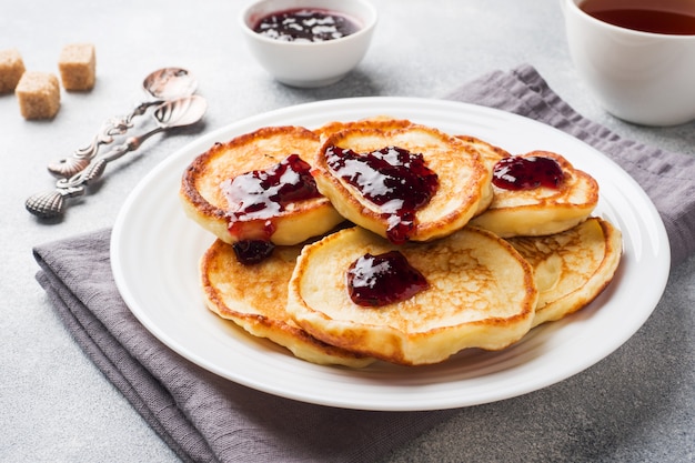 Cottage cheese pancakes with jam and tea. Concept healthy Breakfast.