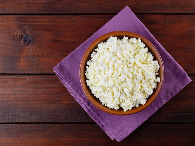 Cottage cheese on wooden boards Fresh cottage cheese in a ceramic bowl Clay plate with soft cheese