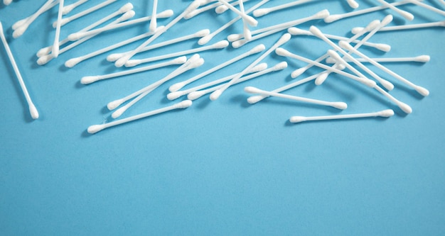 Cotton buds or swabs for ear cleaning on the blue background