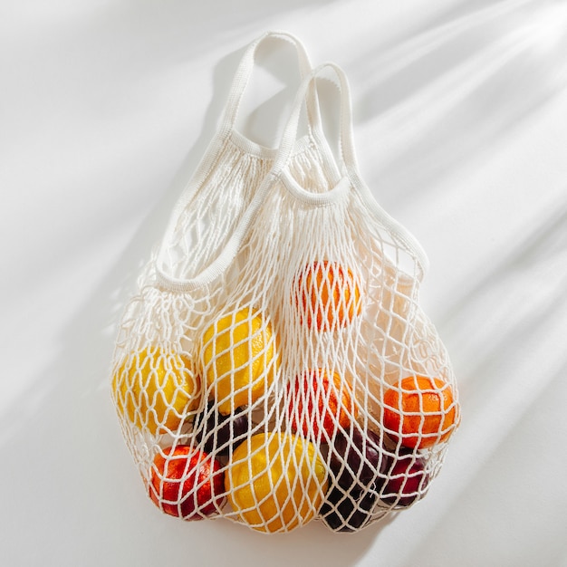 Cotton net bag with fruits. Sustainable lifestyle.  Eco friendly concept.