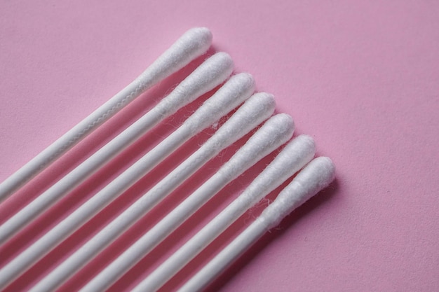 cotton swabs on the pink background, cosmetic and hygienic product