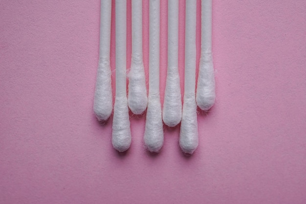 cotton swabs on the pink background, cosmetics and hygiene