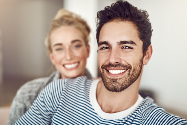 Couch portrait and couple together in living room for bonding care and affection for romance in home Woman man and happy in lounge apartment or house for weekend relaxing rest on sofa with smile