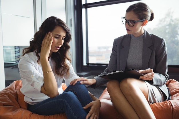 Counselor consoling unhappy woman